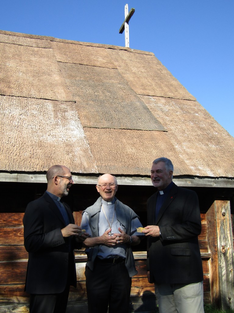 Father Bernard Carroll, S.J. presents Father Peter Bisson, S.J. and Father Jean-Marc Biron, S.J. with crosses made from a cherry wood tree felled on Martyrs' Shrine property. Presentation of the crosses at Sainte Marie Among the Hurons. 